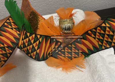 Colorful patterned belt with feathers displayed.