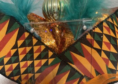 Colorful feathers and fabric with geometric patterns.