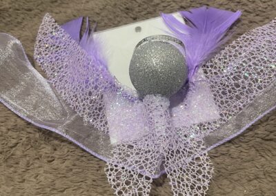 Sparkly purple bow with glittery ornament.